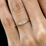 Close up worn view of tapered five stone baguette moissanite ring.