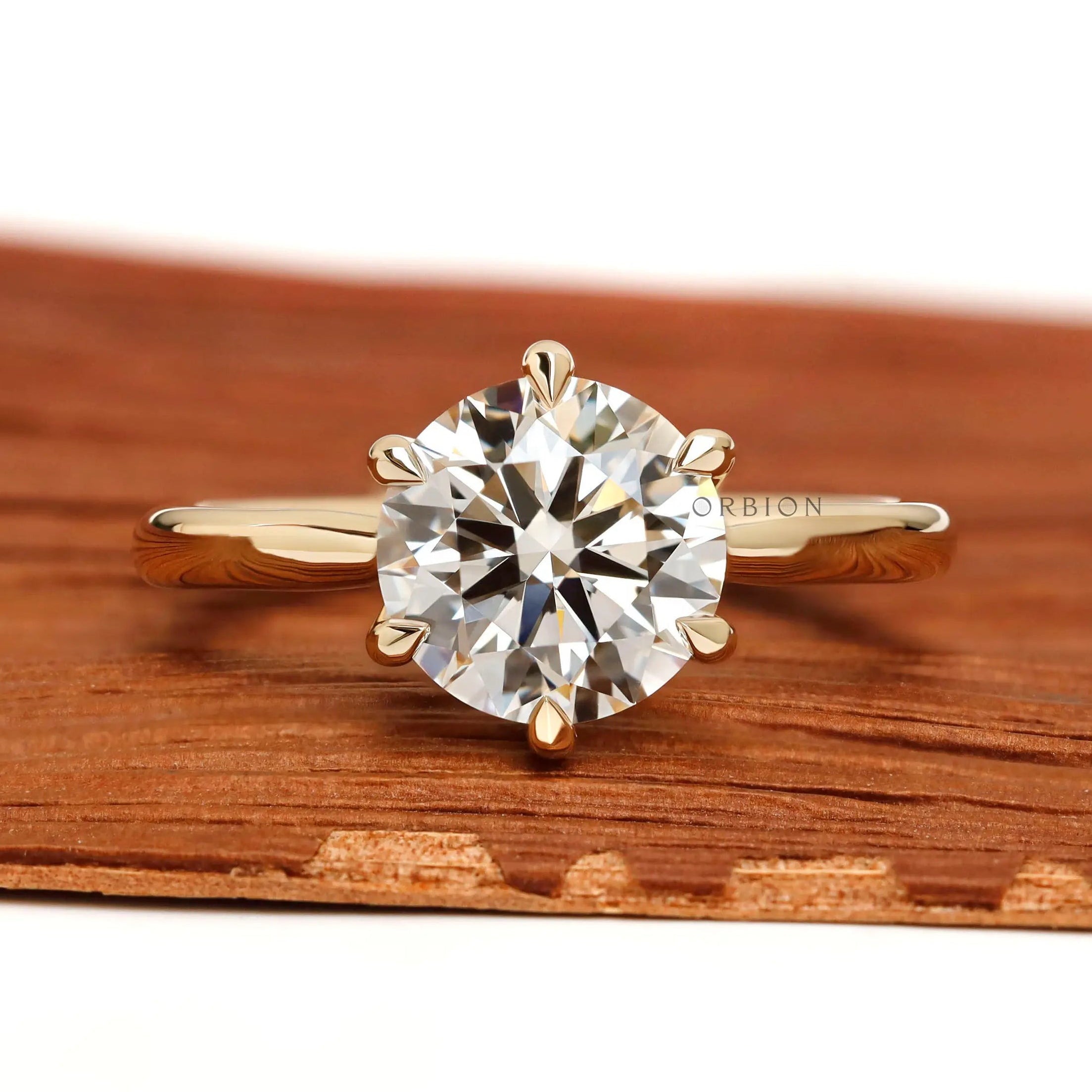 Front view round solitaire lab diamond ring in yellow gold.
