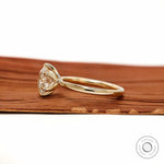 Side profile showing twisted gallery and round solitaire setting.