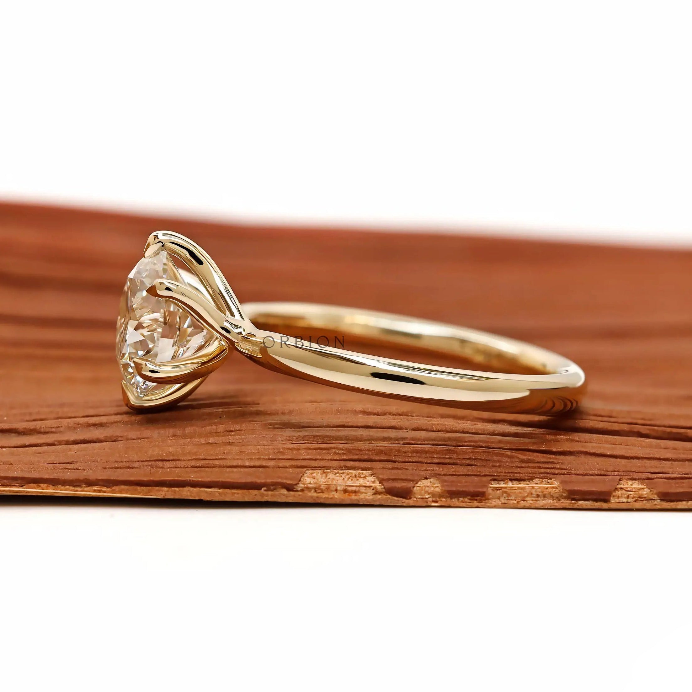 Side profile showing twisted gallery and round solitaire setting.