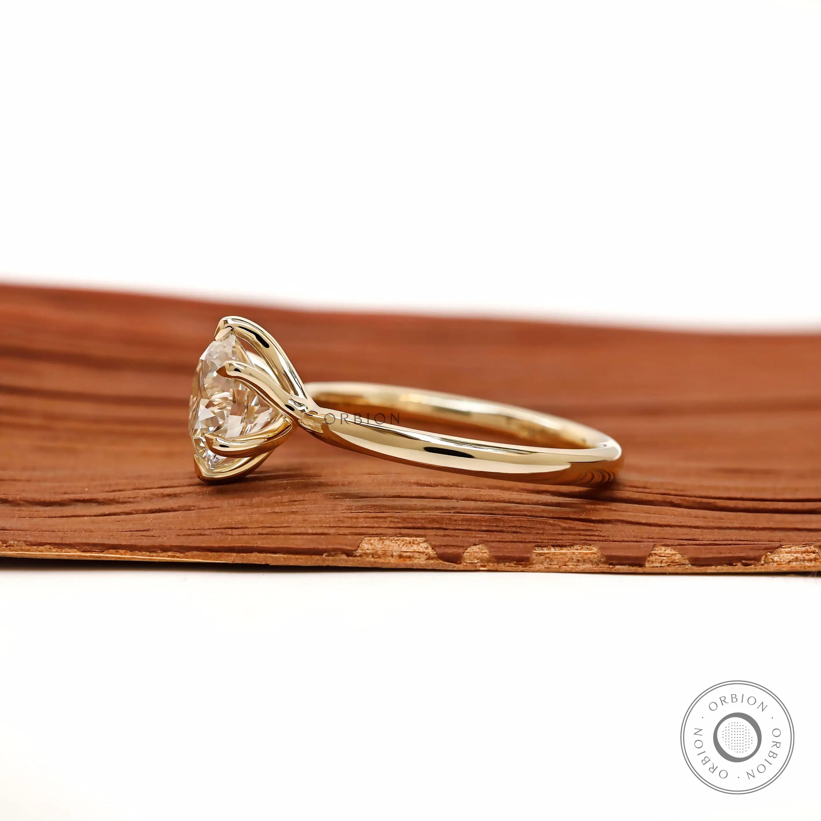 Side profile showing twisted gallery and round solitaire setting.