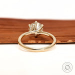 Back view of twisted solitaire ring with polished gold band.