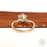 Back view of twisted solitaire ring with polished gold band.