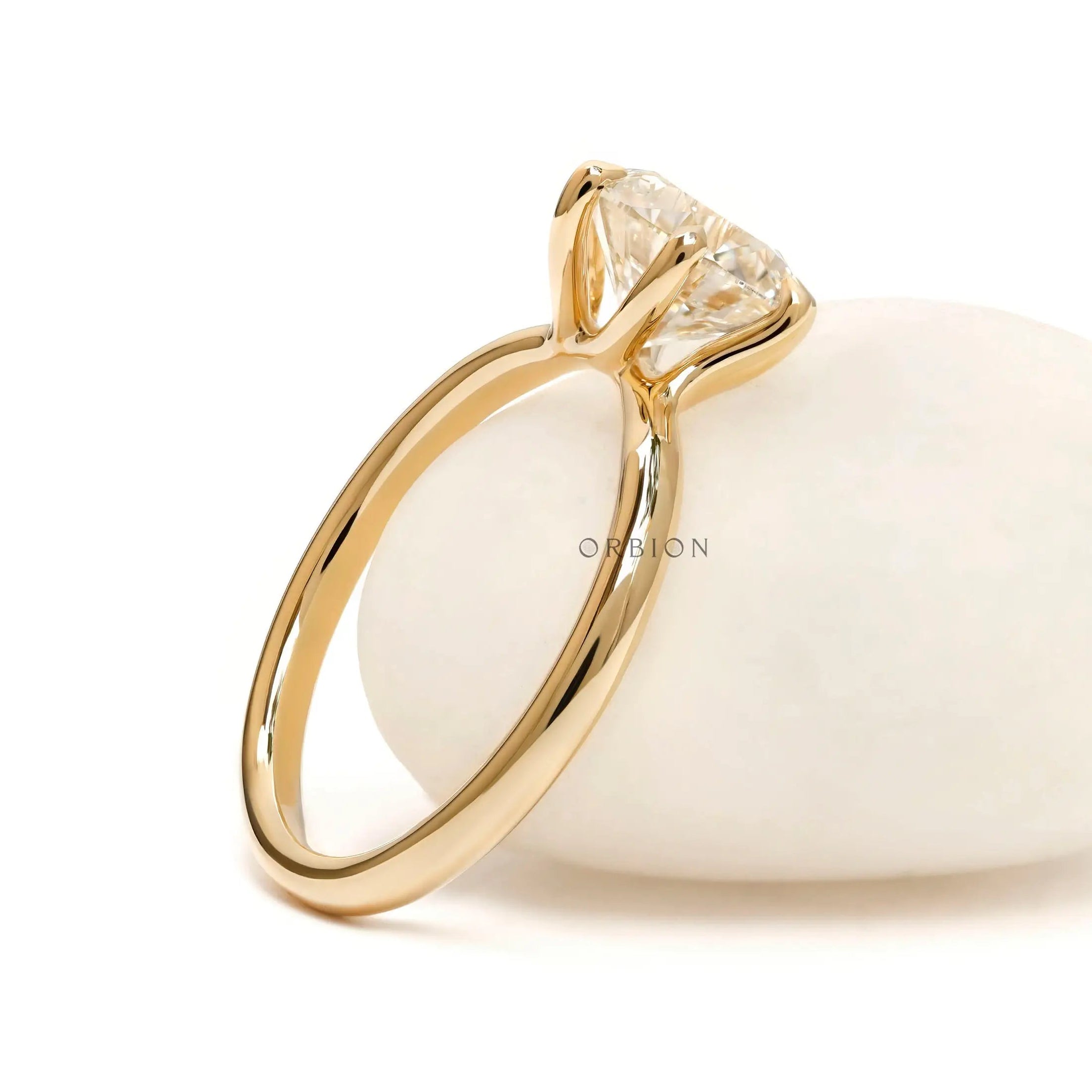 Back angled view highlighting twisted gallery beneath round diamond.