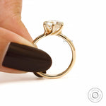 Held angle view showing twisted cathedral style solitaire ring.