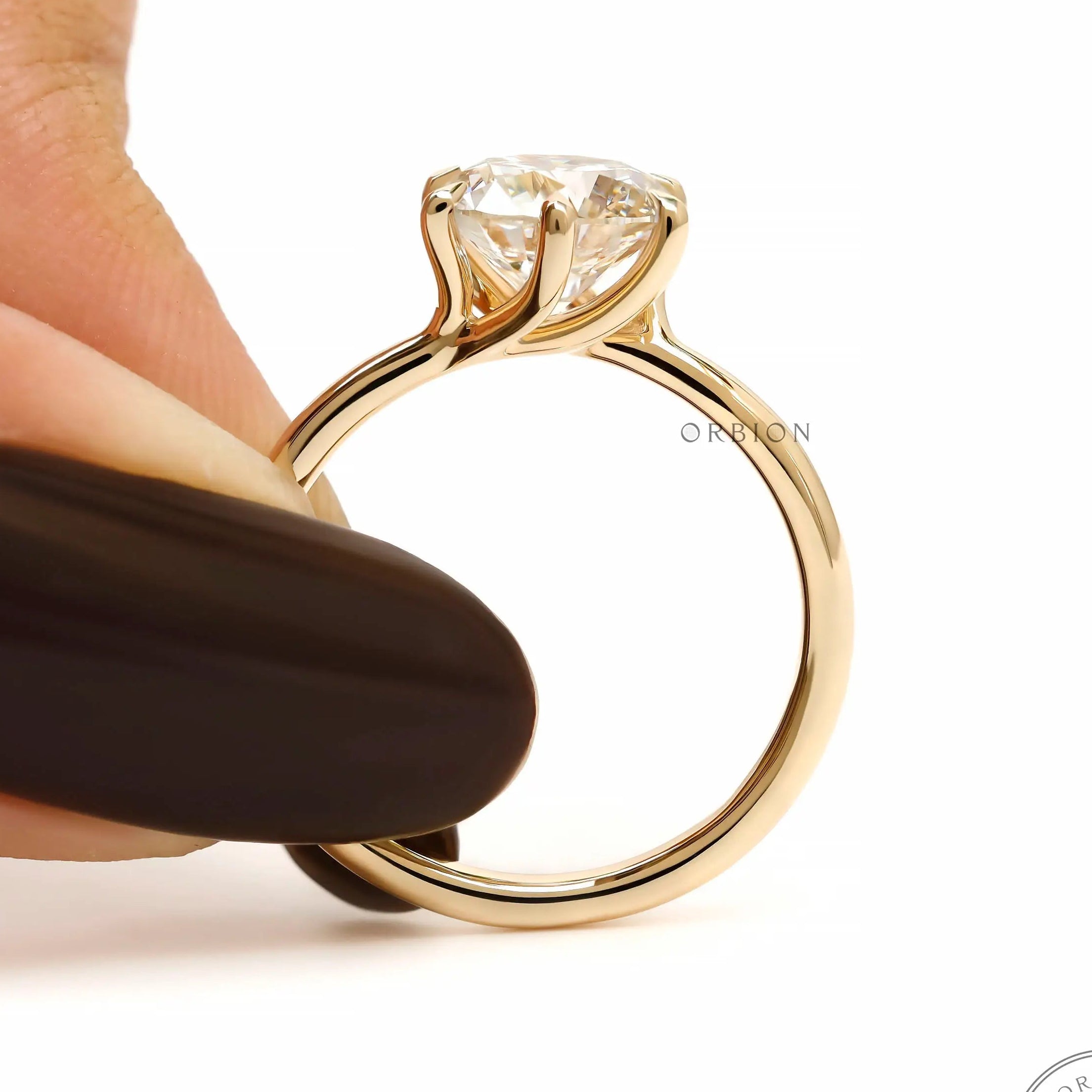 Held angle view showing twisted cathedral style solitaire ring.