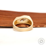 Close-up of marquise moissanite bezel set in signet ring