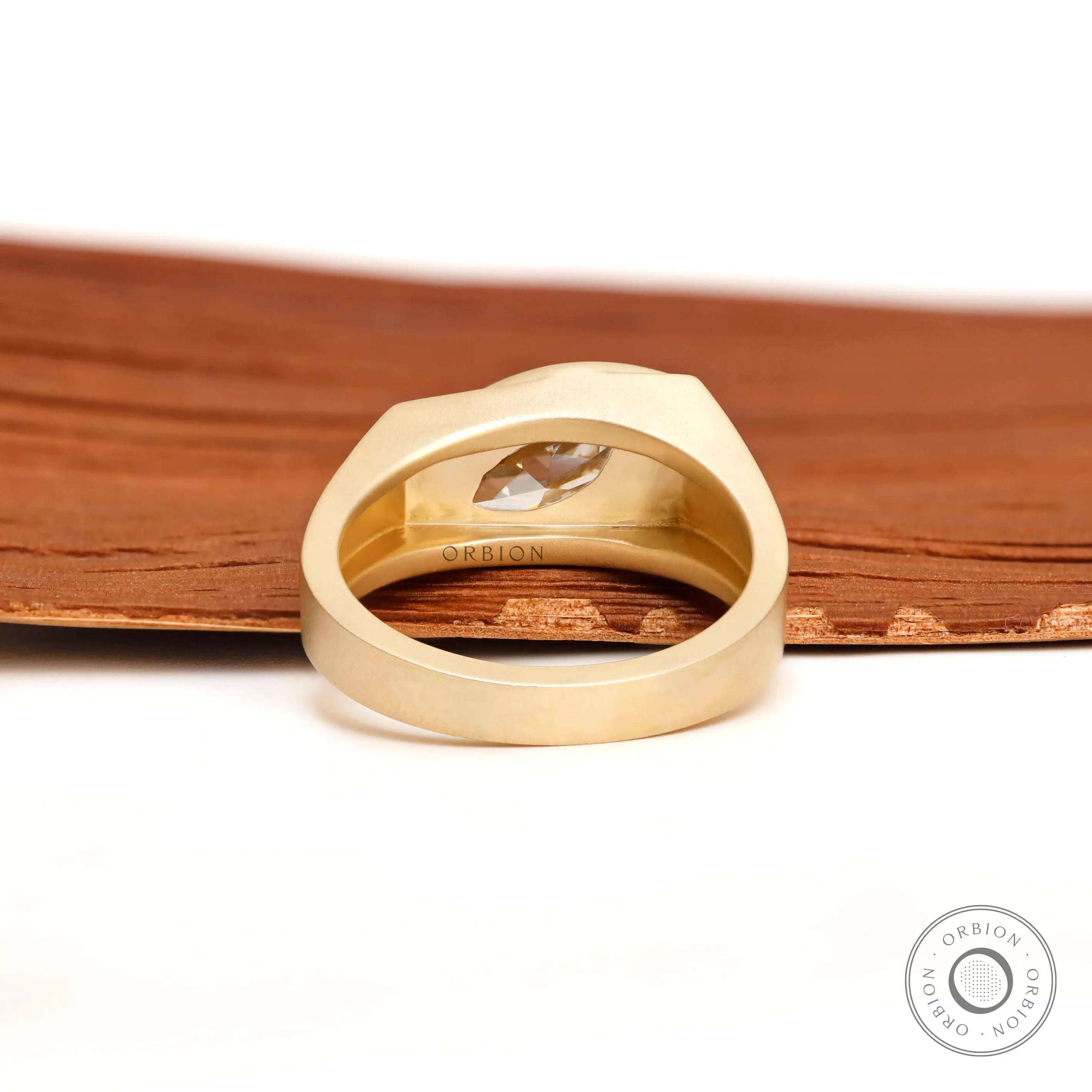 Close-up of marquise moissanite bezel set in signet ring