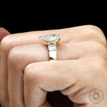 Top hand view pear lab diamond ring with baguette sides