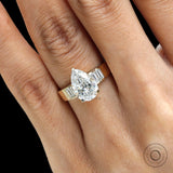 Close finger shot pear diamond ring in yellow gold