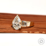 Angled front view pear diamond ring with baguette accents
