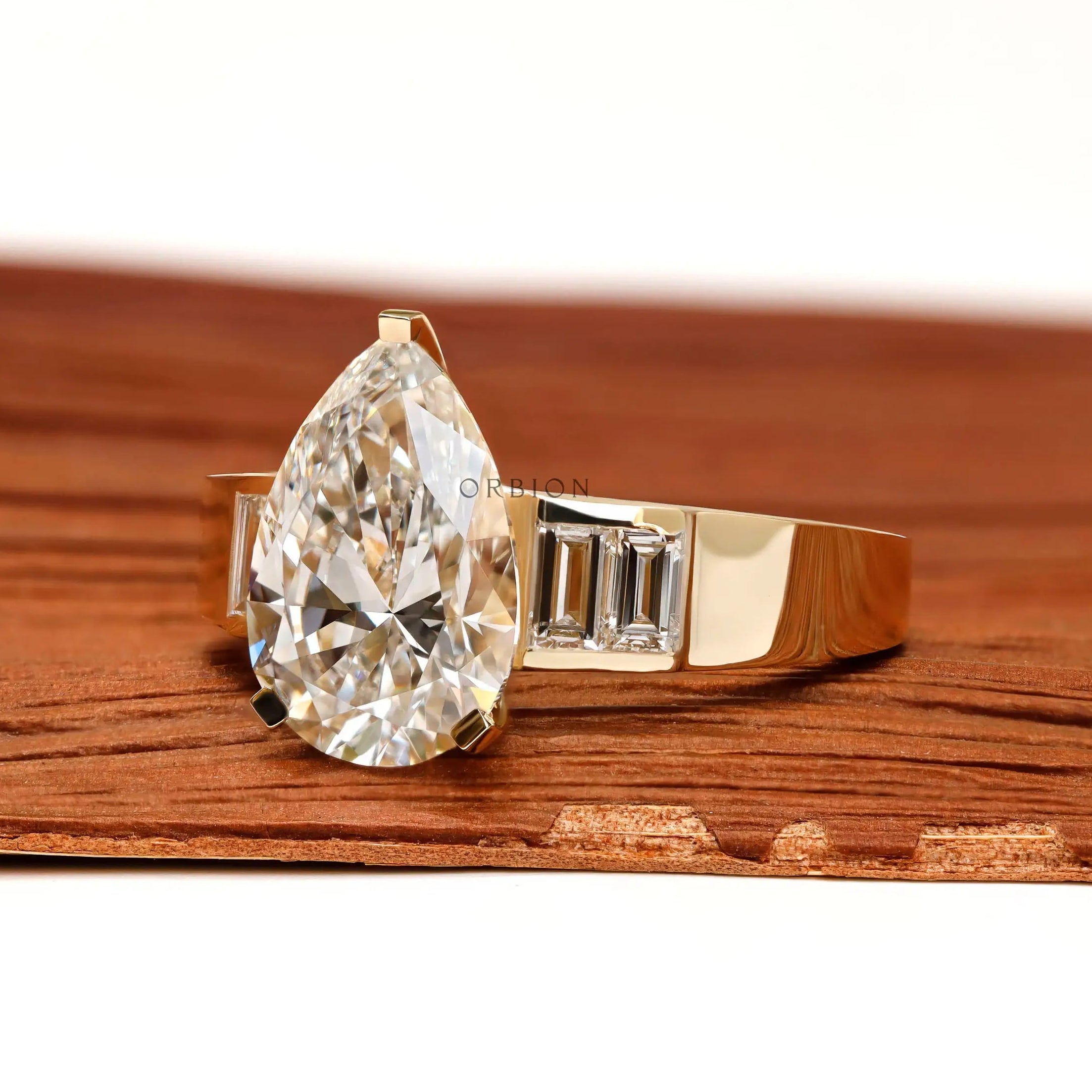Angled front view pear diamond ring with baguette accents