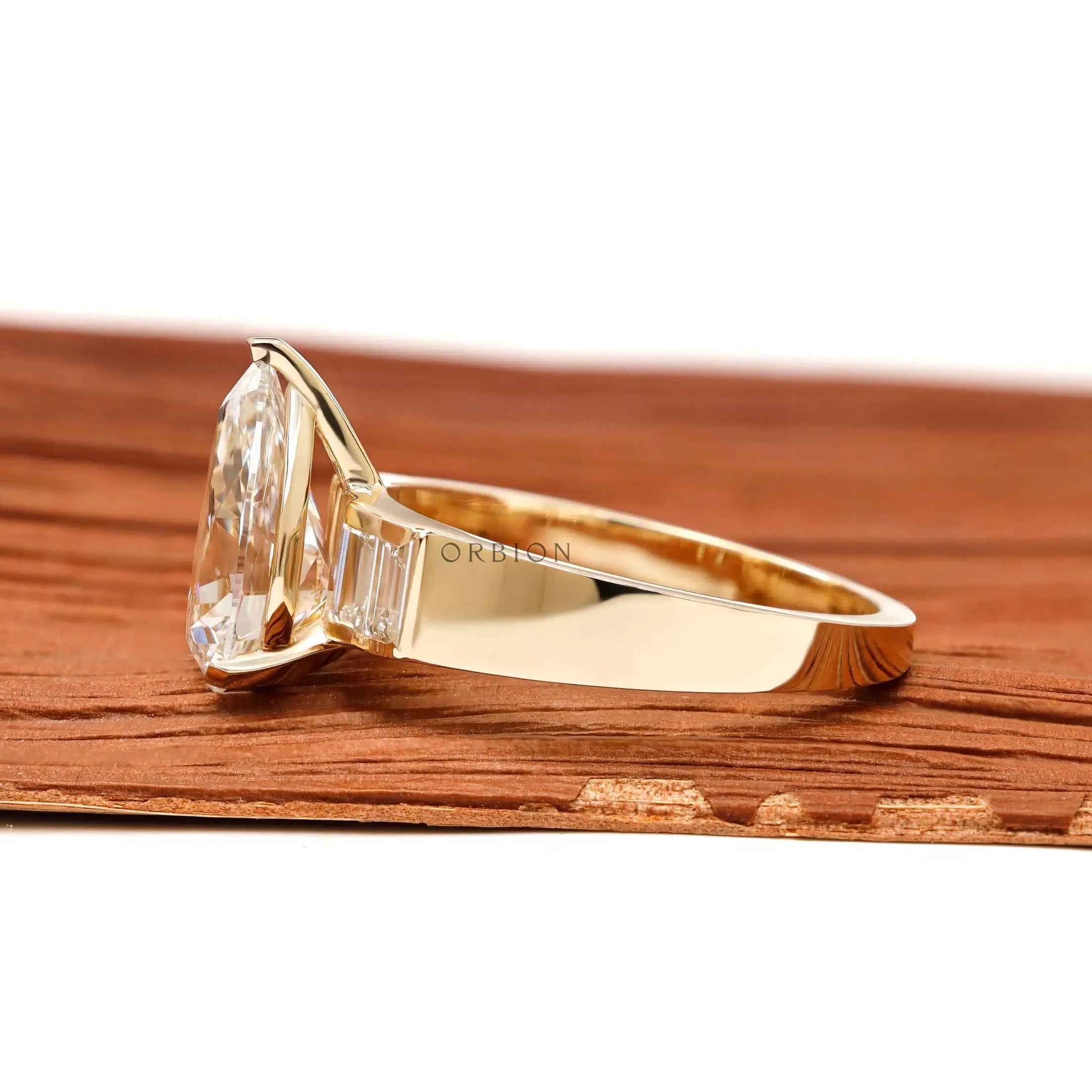 Side profile pear lab diamond ring with tapered yellow gold band