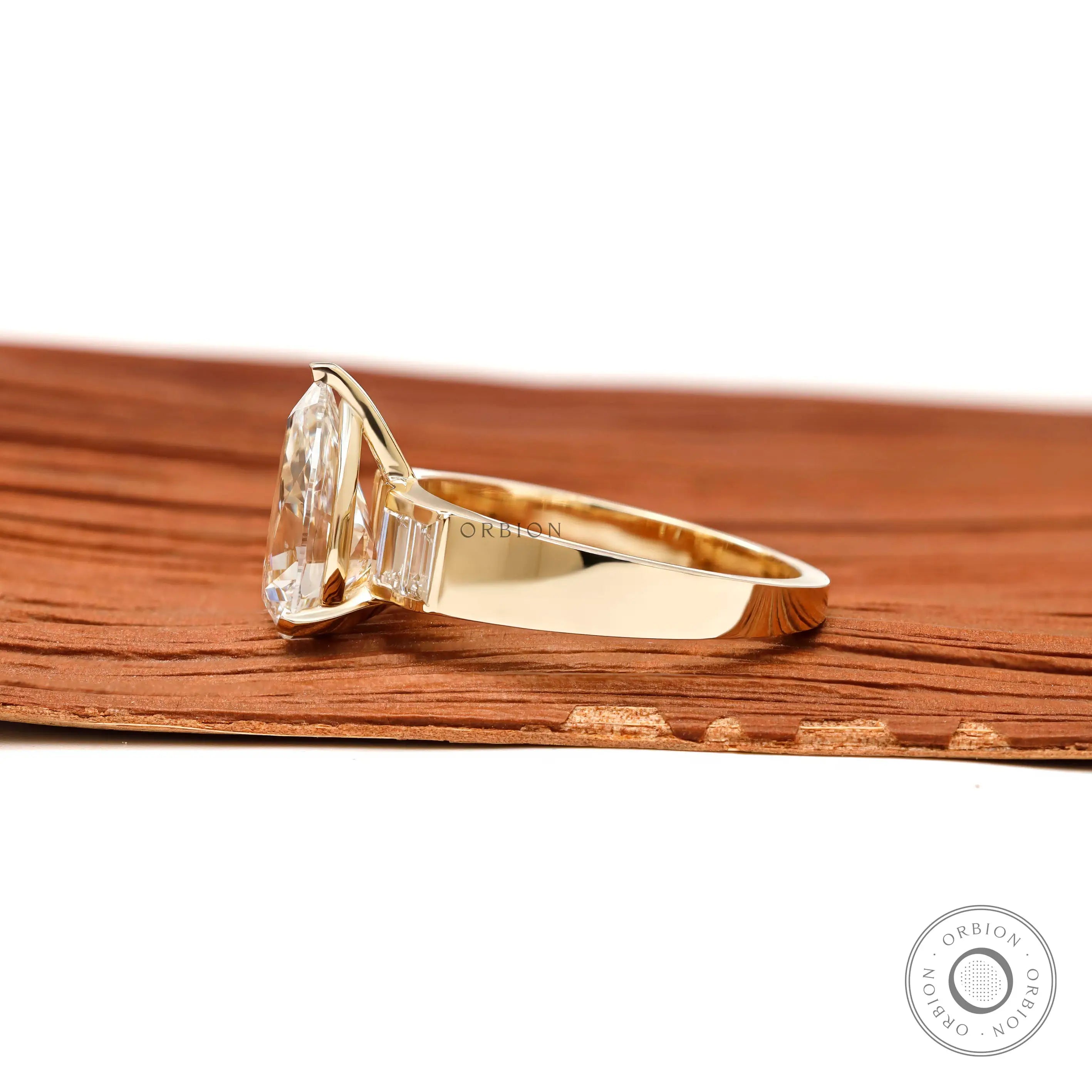 Side profile pear lab diamond ring with tapered yellow gold band