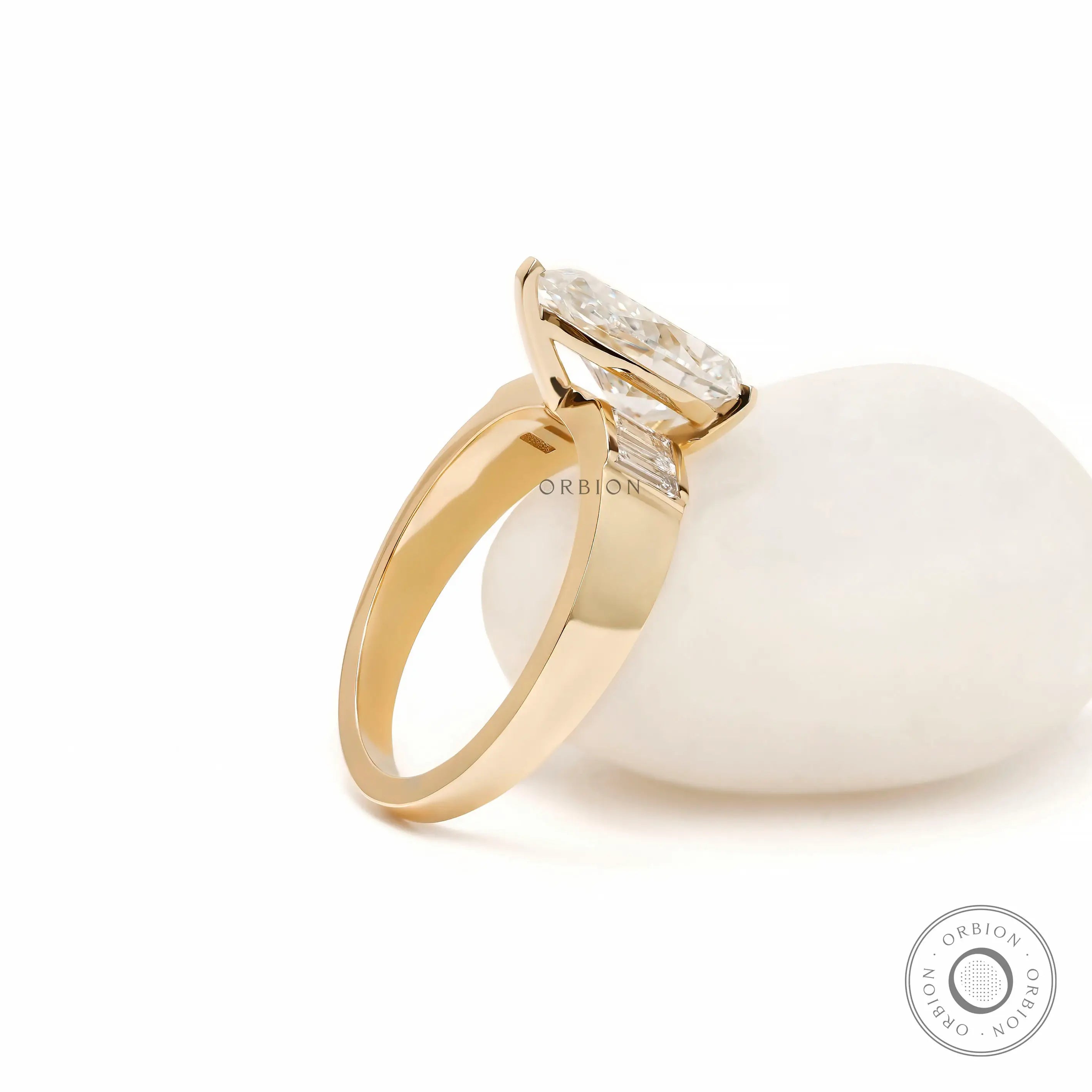 Rear angled view pear diamond ring on white display stone