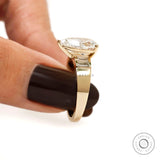 Close side detail pear diamond ring with baguette side setting