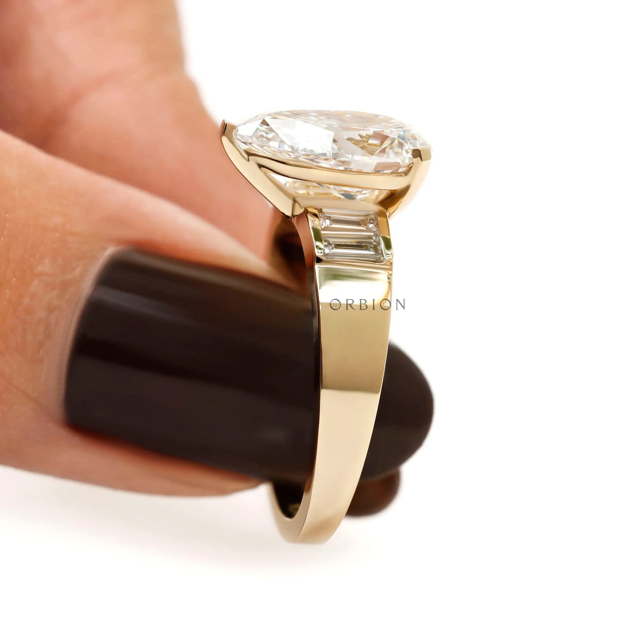 Close side detail pear diamond ring with baguette side setting