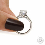 2 Ct cushion moissanite engagement ring with platinum band, hidden halo, and timeless bridal design