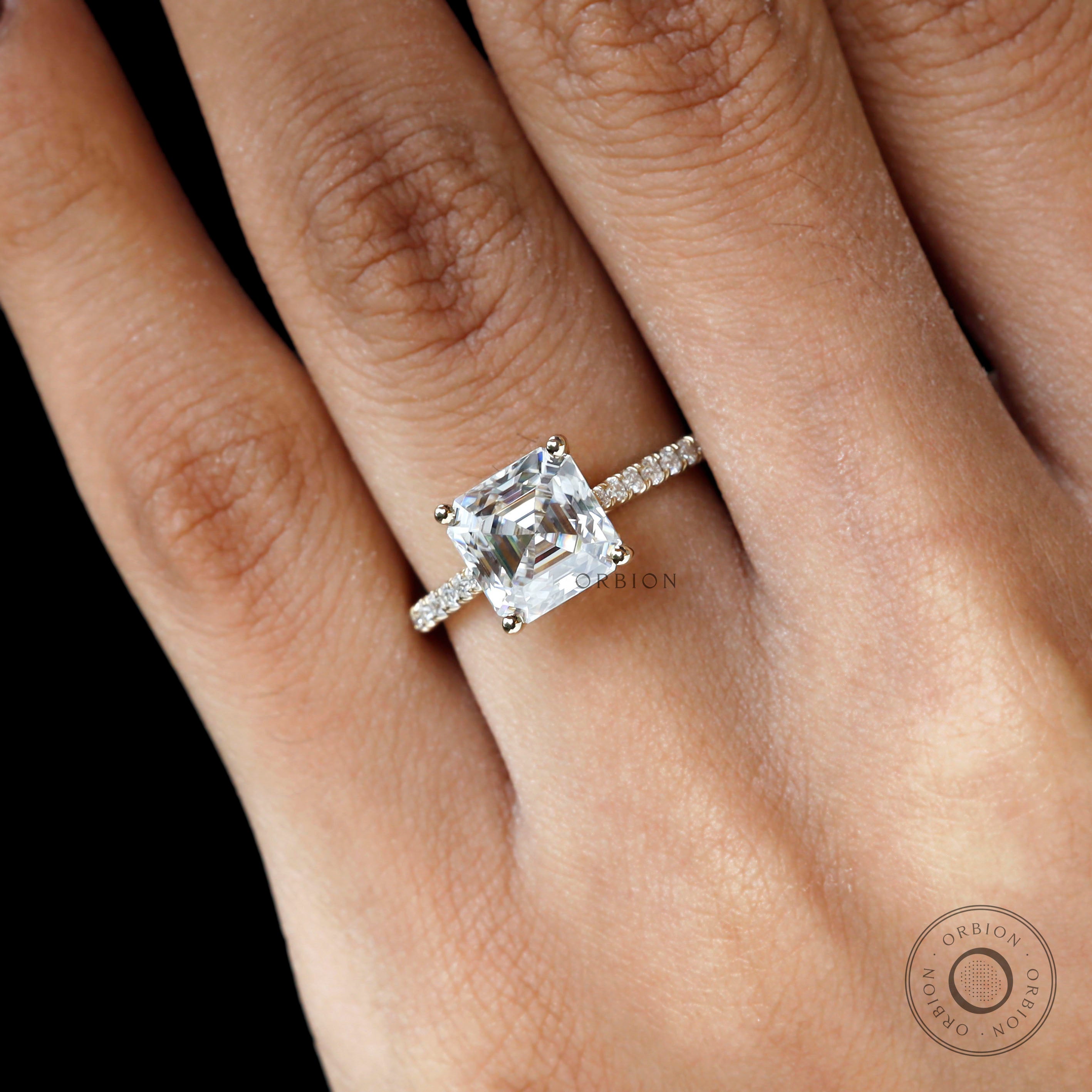 Yellow gold asscher step cut solitaire engagement ring close up