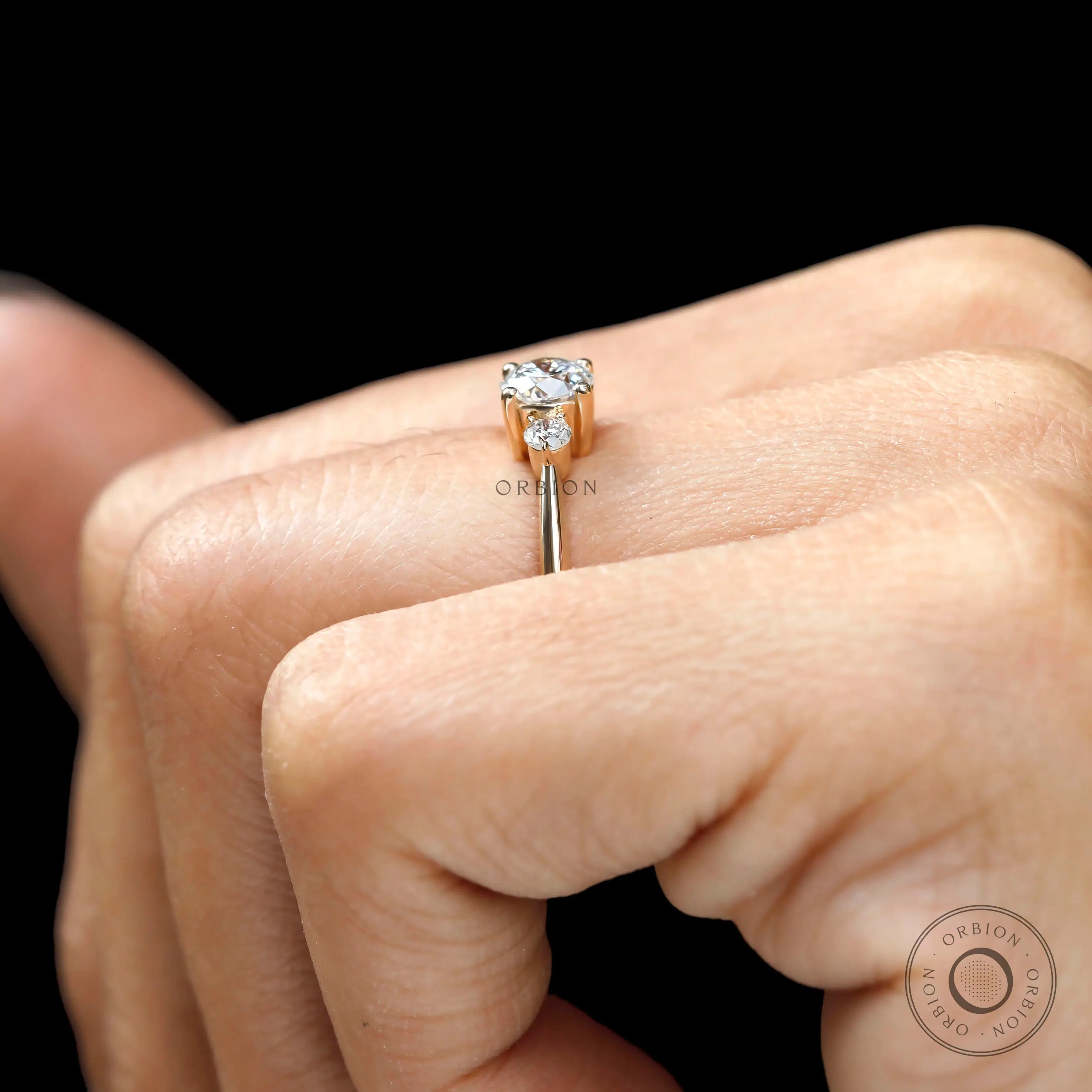 Trilogy round cut lab diamond ring with side stones detail