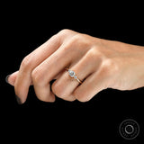 Minimal yellow gold three stone ring on finger