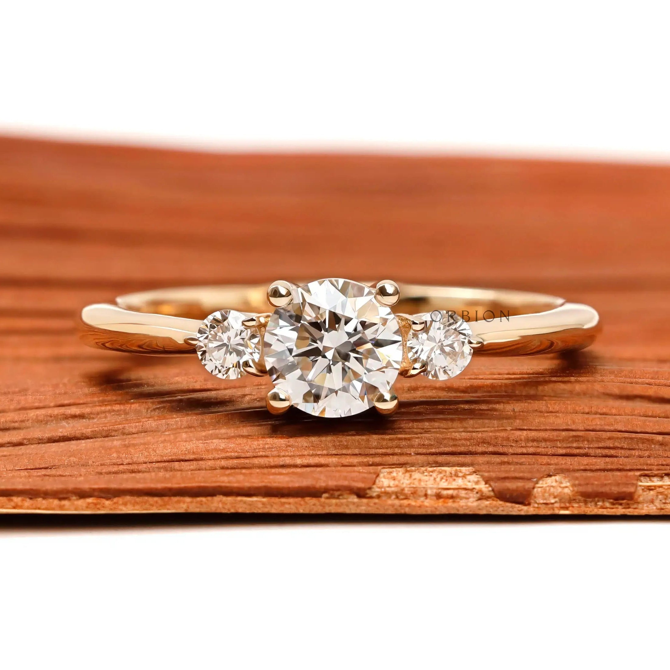Round cut three stone diamond ring in 10k yellow gold front view