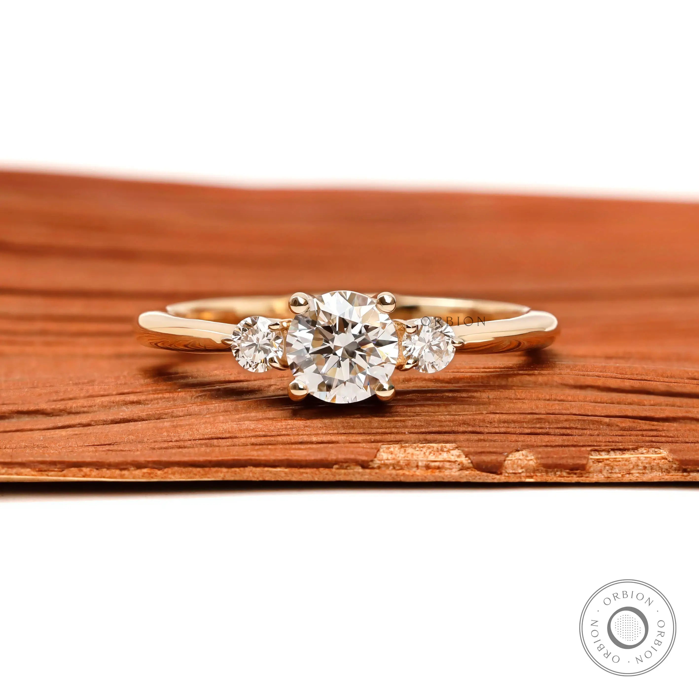 Round cut three stone diamond ring in 10k yellow gold front view