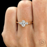 close up of minimalist oval three stone lab diamond ring in 10k yellow gold