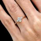 Close up of sparkling oval center stone and round accent stones lab grown diamond 3 stone ring