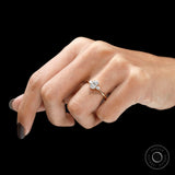 Minimalist oval engagement ring crafted in 10k yellow gold on finger