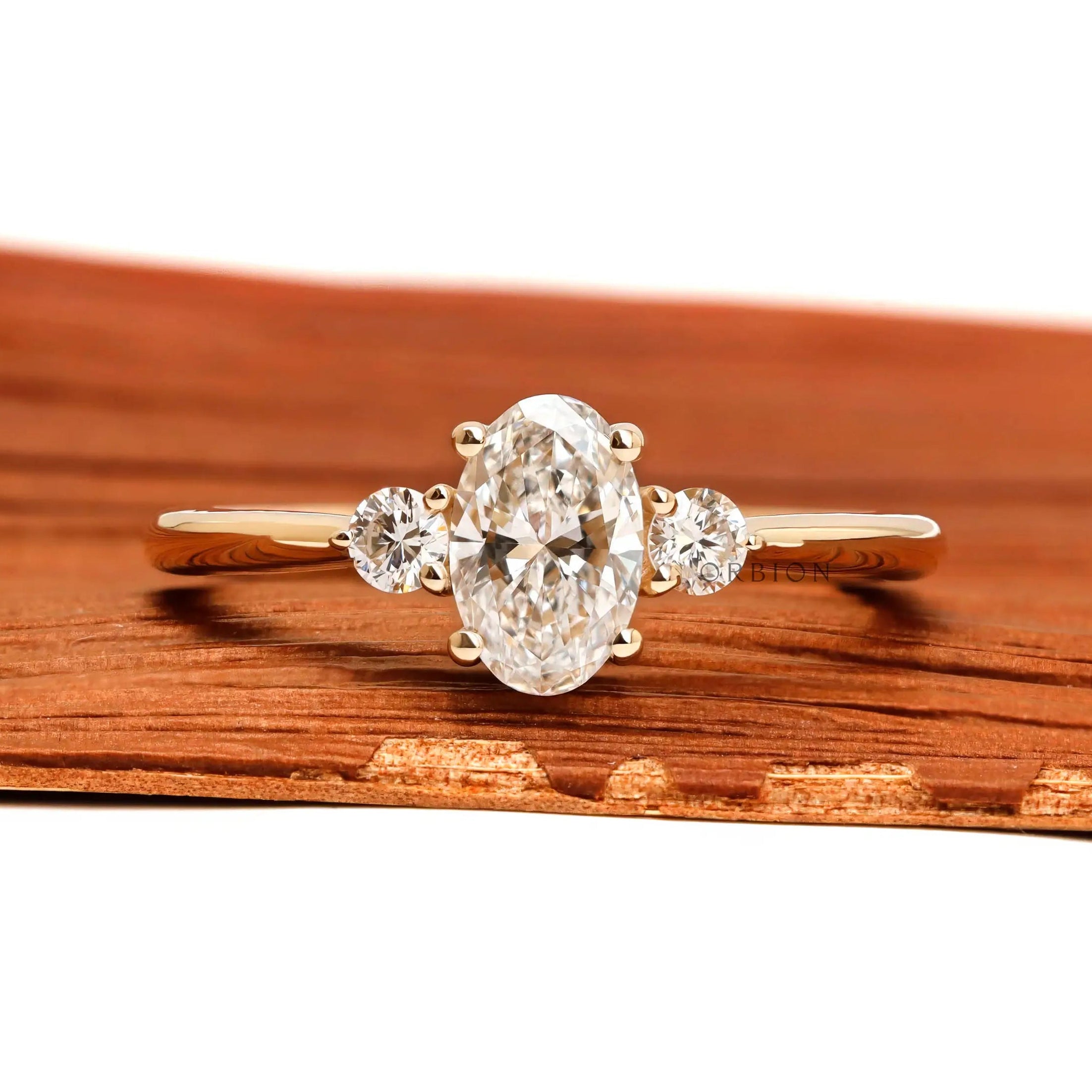 Dainty oval three stone lab diamond ring in 10k yellow gold front view