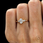 Close up of three stone oval and pear lab diamond wedding ring