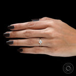 minimalist oval pear trilogy diamond ring on finger
