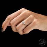 Elegant three stone engagement ring oval pear design on finger