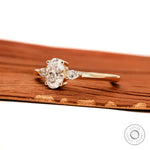 Side view of oval and pear lab diamond ring in yellow gold