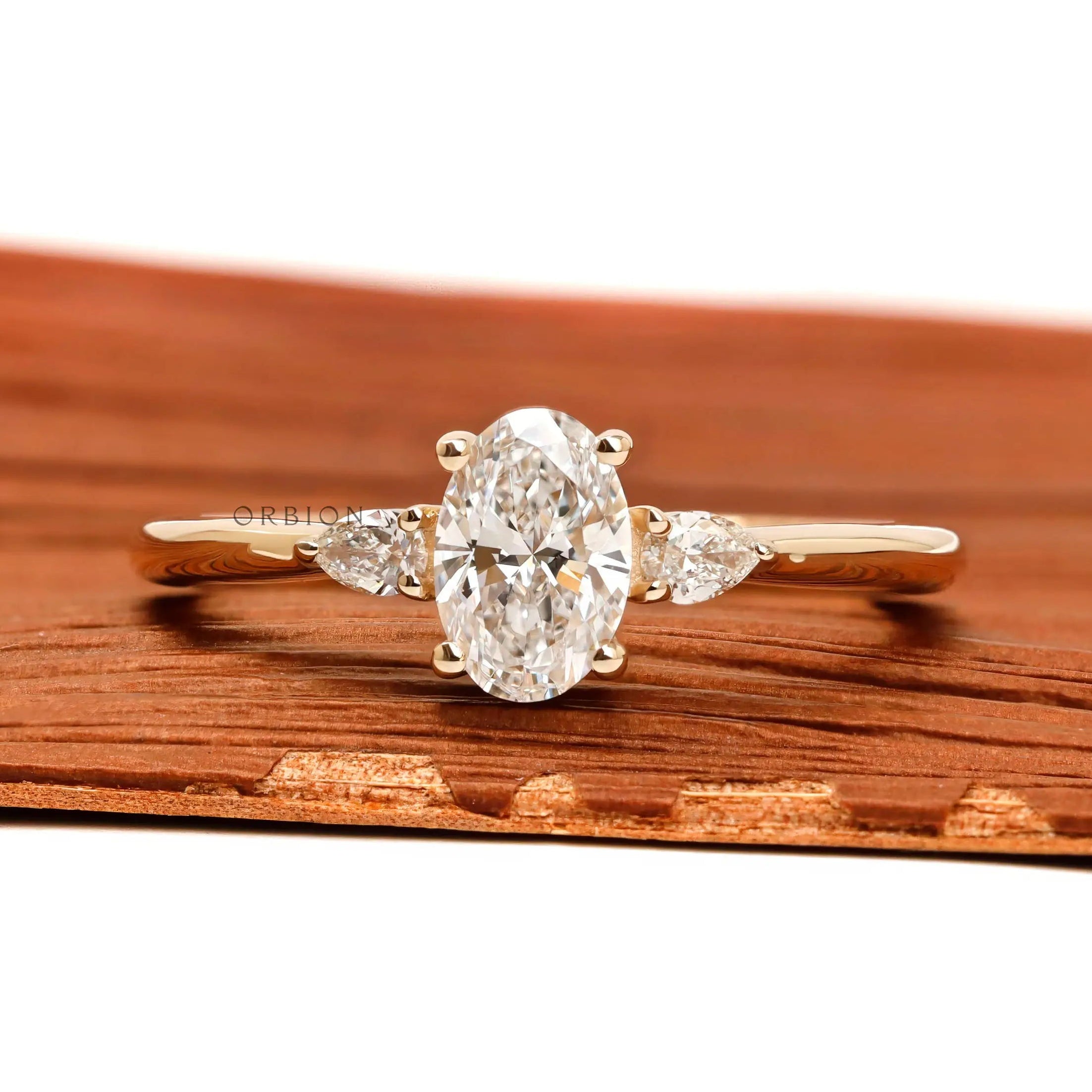 Oval and pear three stone lab grown diamond ring in 10k yellow gold
