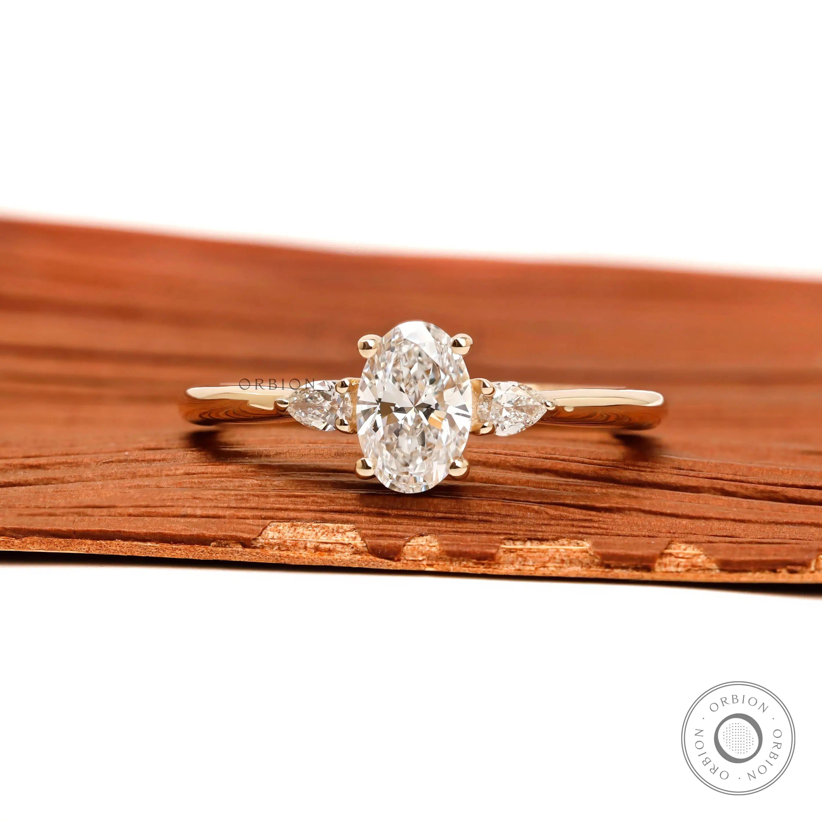 Oval and pear three stone lab grown diamond ring in 10k yellow gold