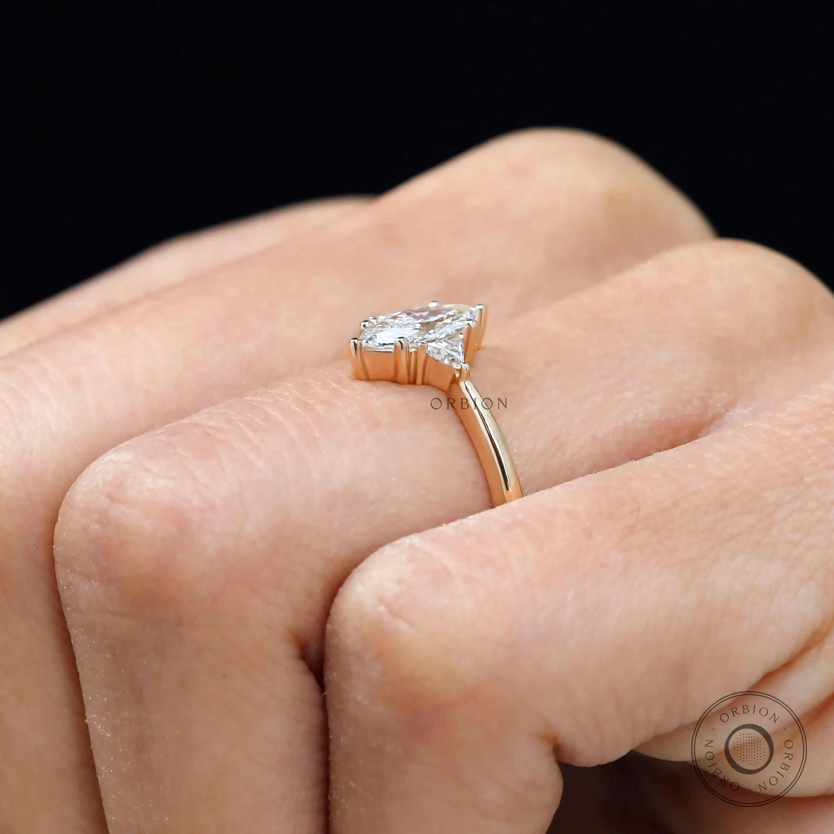 Triangle side stone detail on three stone engagement ring
