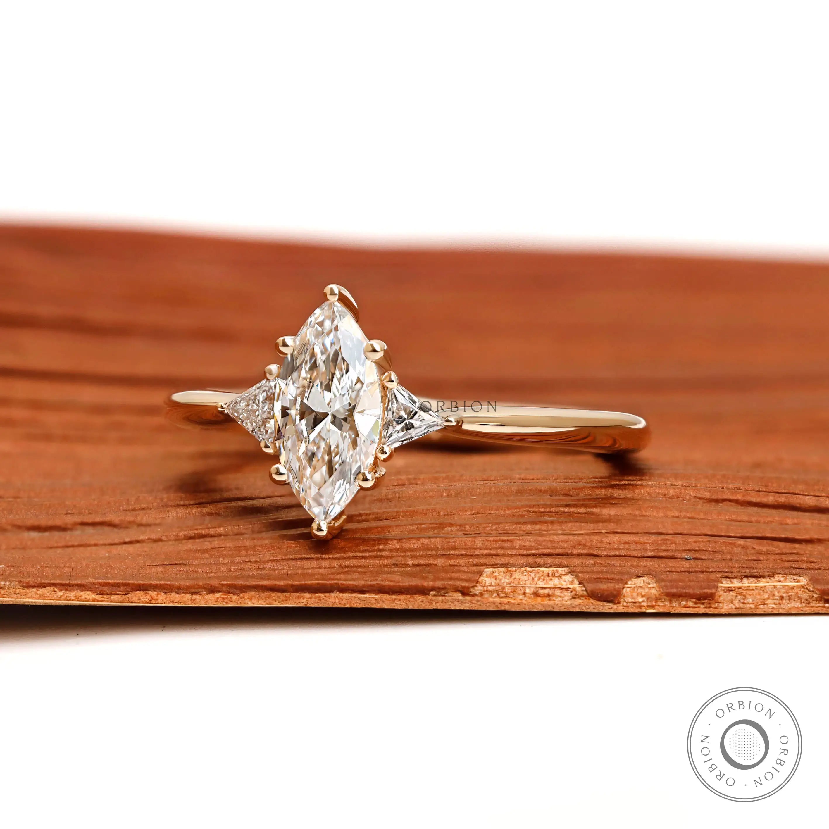 Marquise moissanite engagement ring with triangle side stones