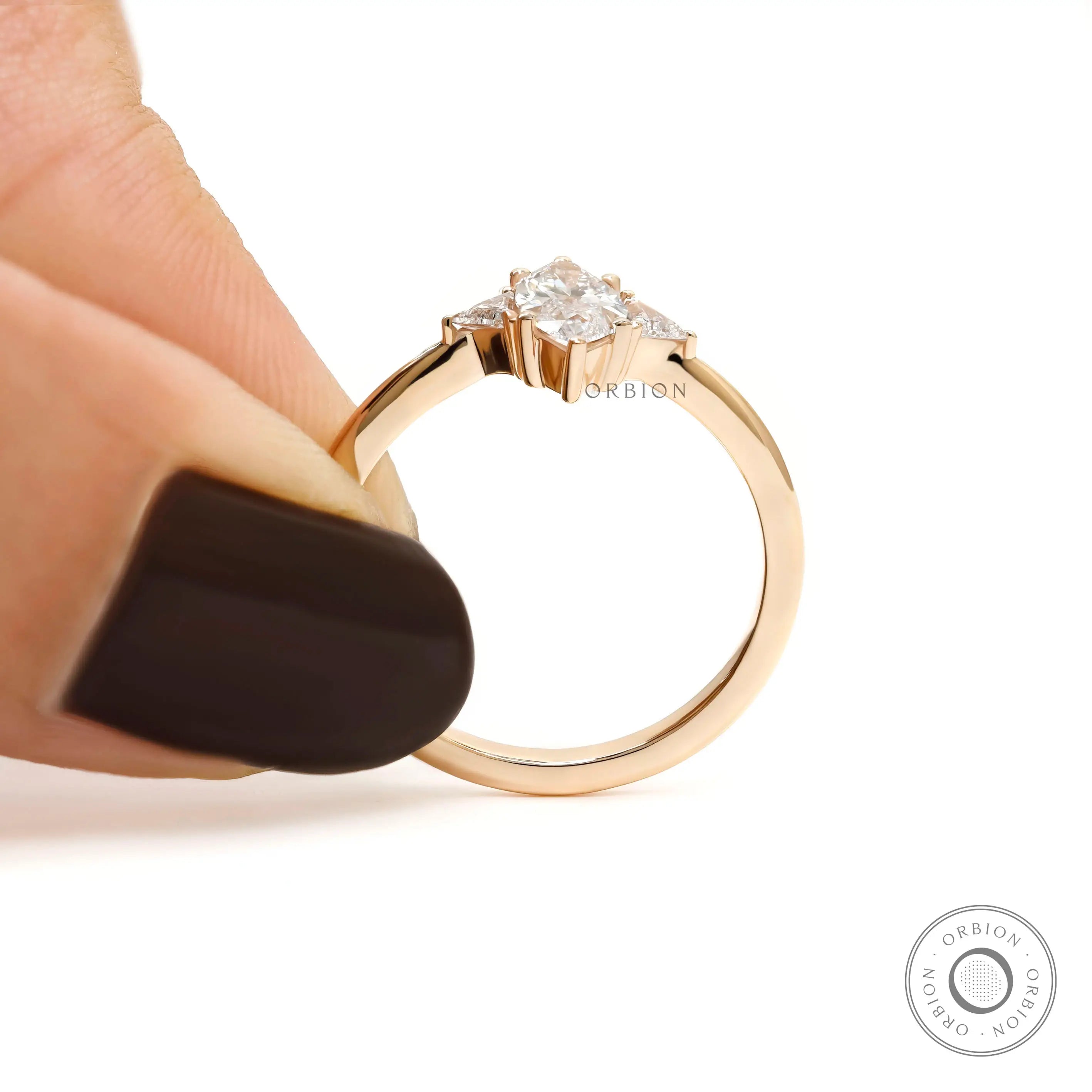 Minimal three stone ring with marquise center diamond