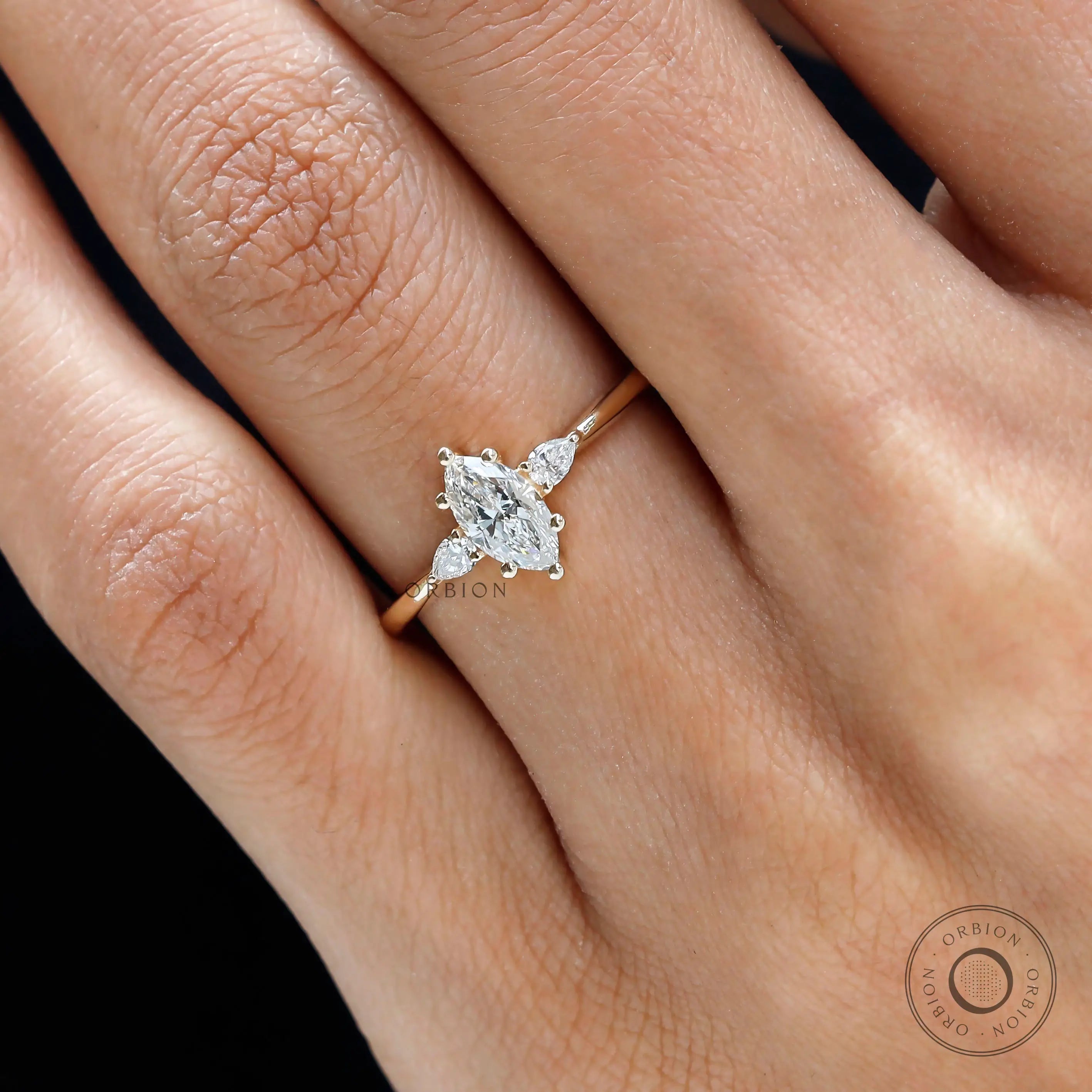 Close up of pear side stones on marquise engagement ring