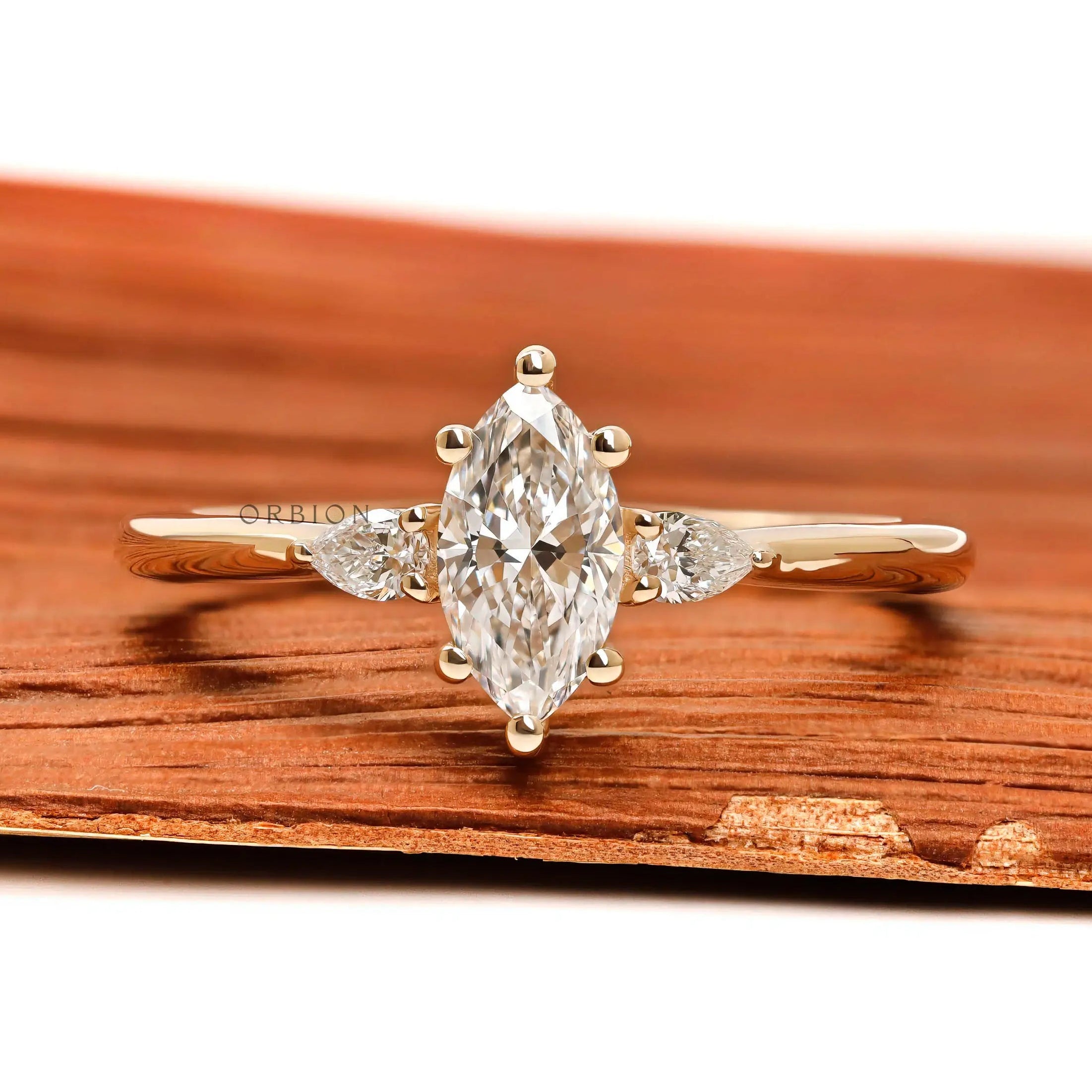 Marquise and pear three stone lab diamond ring in 10k yellow gold front view