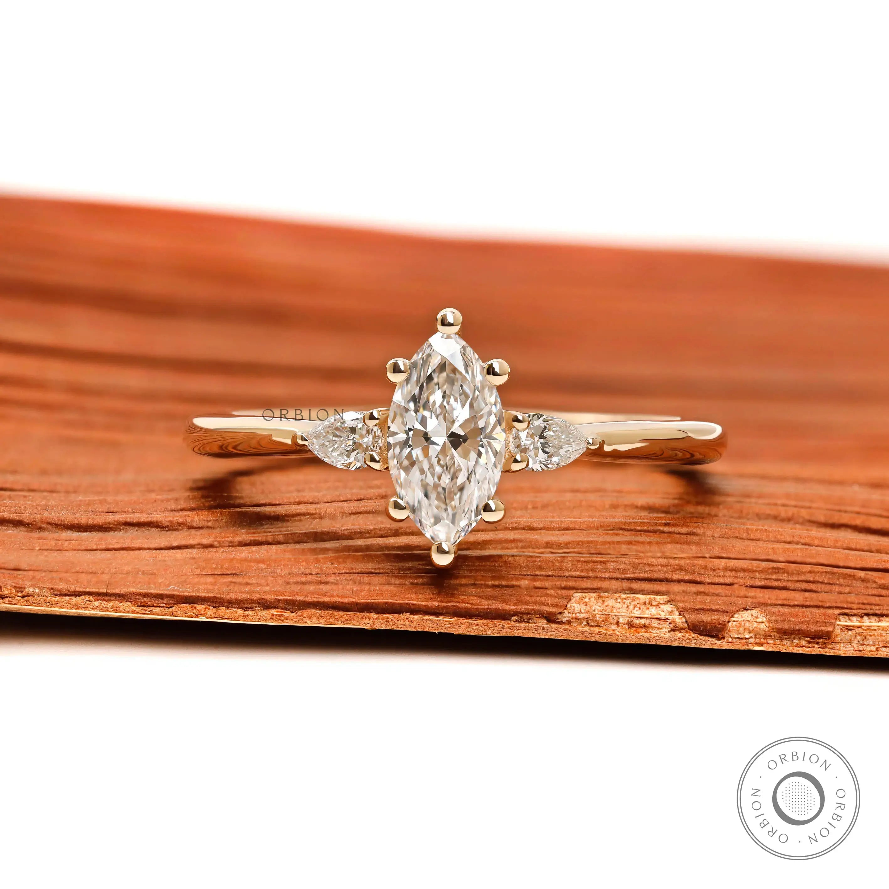 Marquise and pear three stone lab diamond ring in 10k yellow gold front view