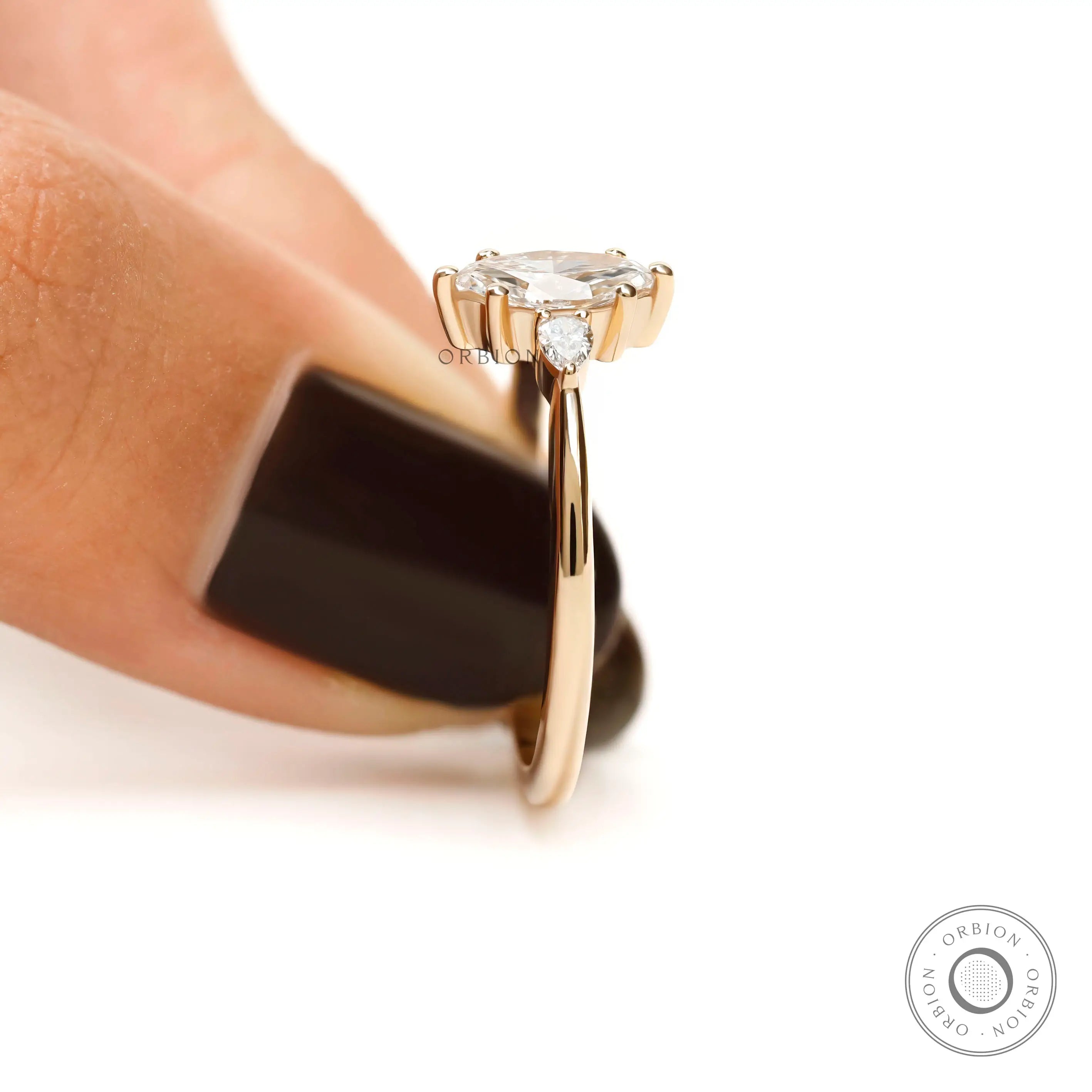 Angled view showing pear accents on marquise ring
