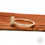 Slim band marquise engagement ring in glossy yellow gold