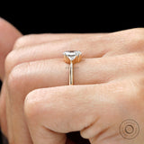 Oval moissanite three stone ring in yellow gold