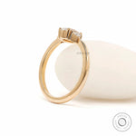 Prong set oval diamond three stone ring yellow gold