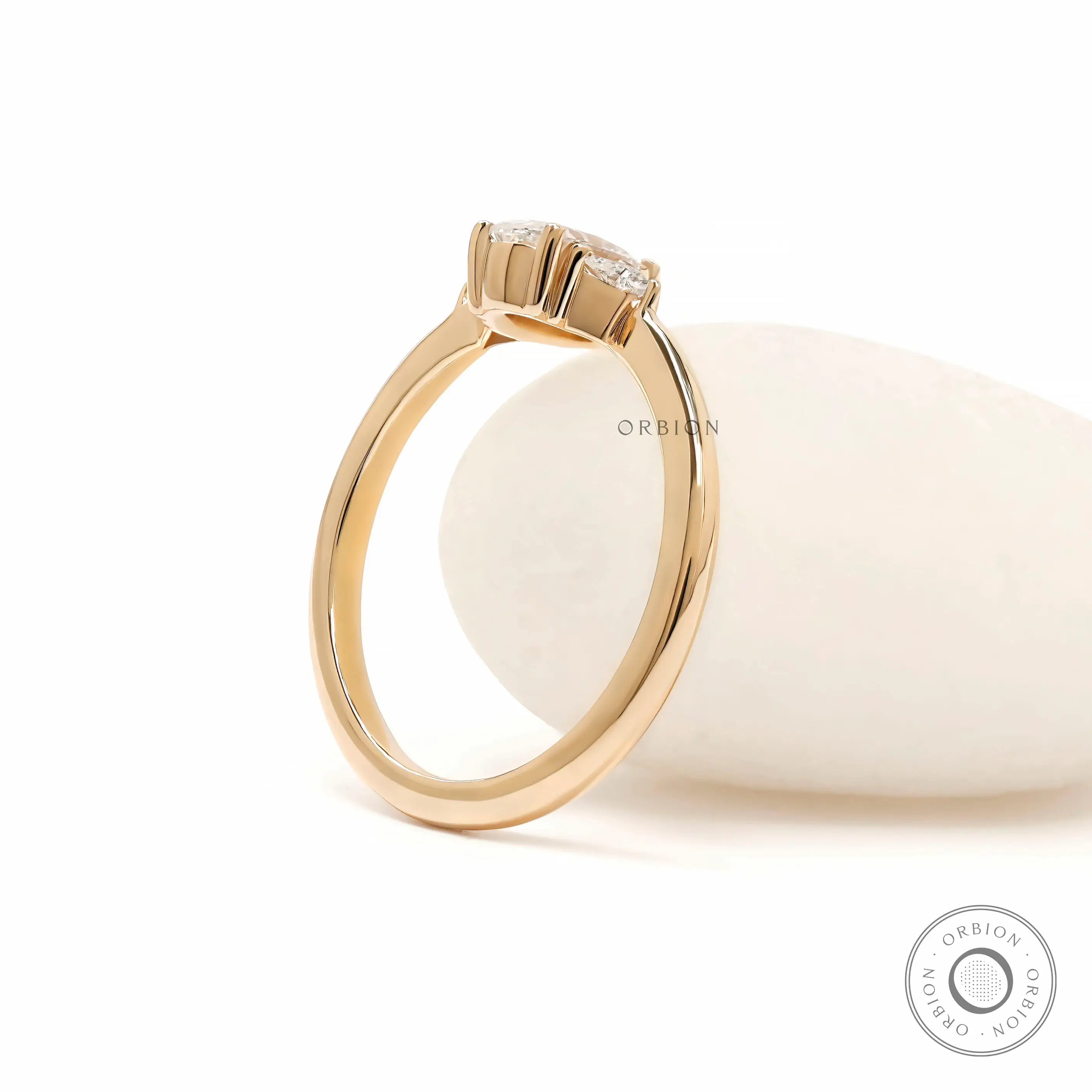 Prong set oval diamond three stone ring yellow gold