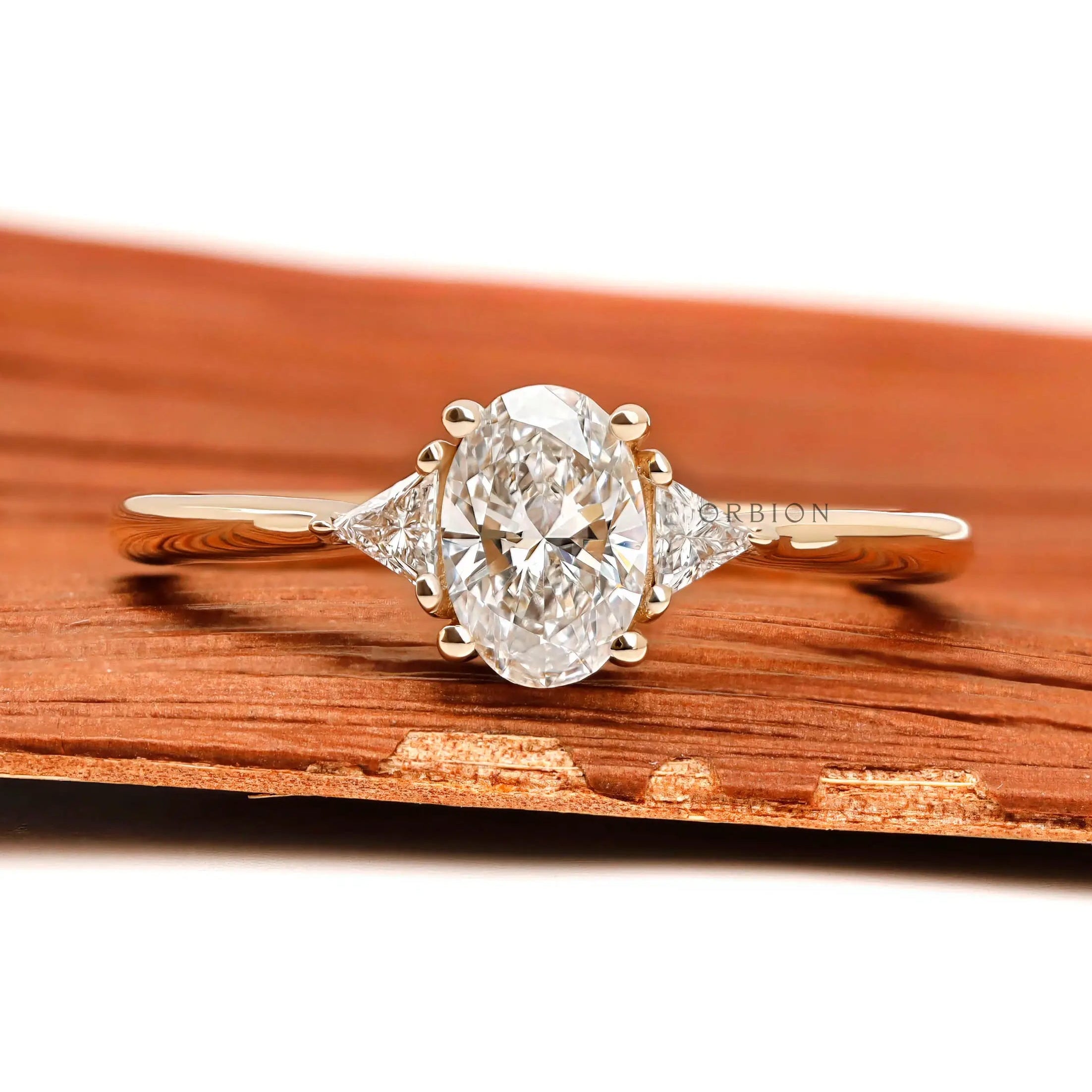 Oval lab diamond three stone ring in 10k yellow gold front view