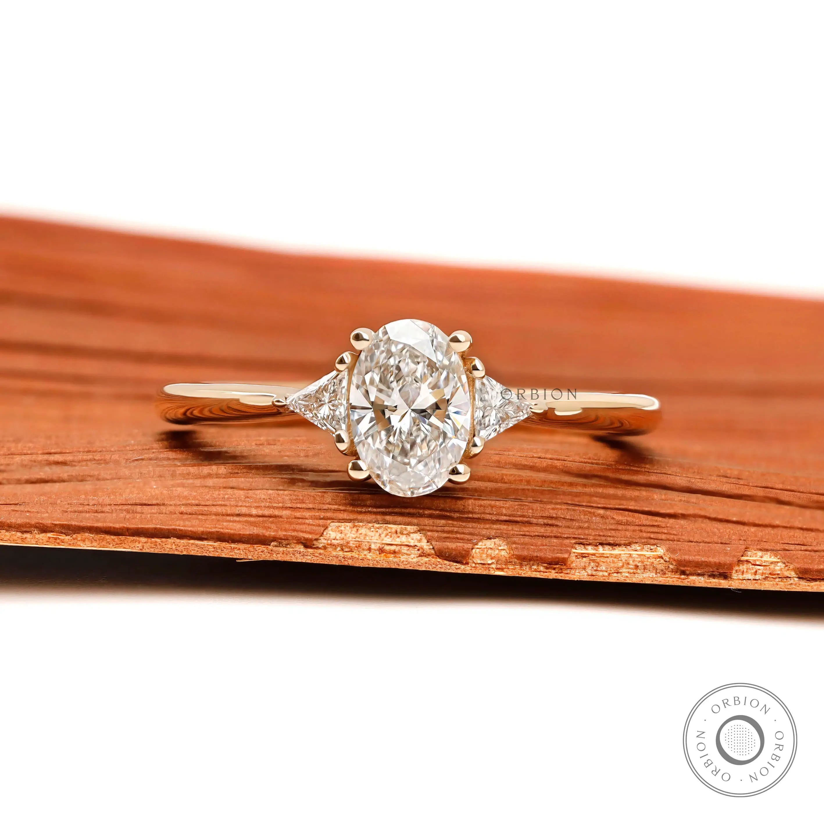 Oval lab diamond three stone ring in 10k yellow gold front view